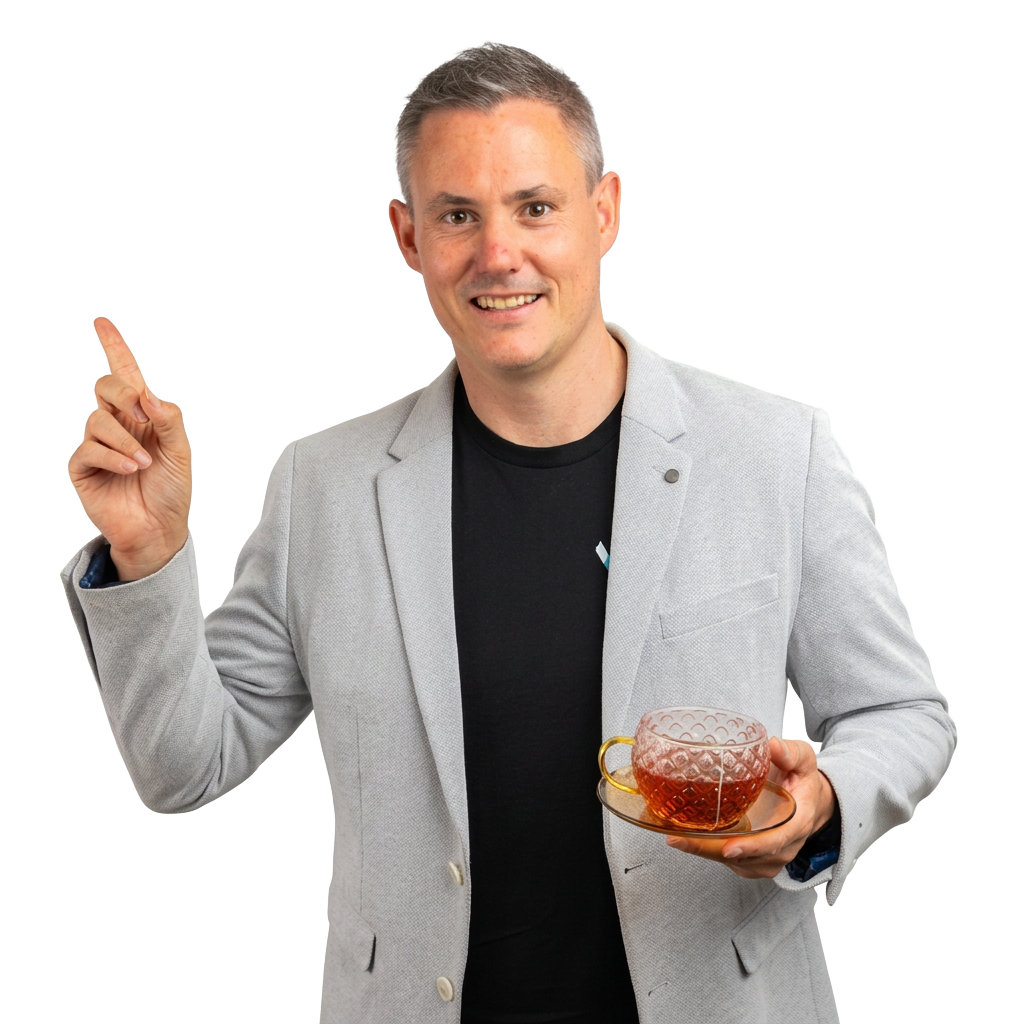 Steve Williams smiling, pointing up and holding a cup of tea